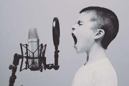 boy in studio singing 